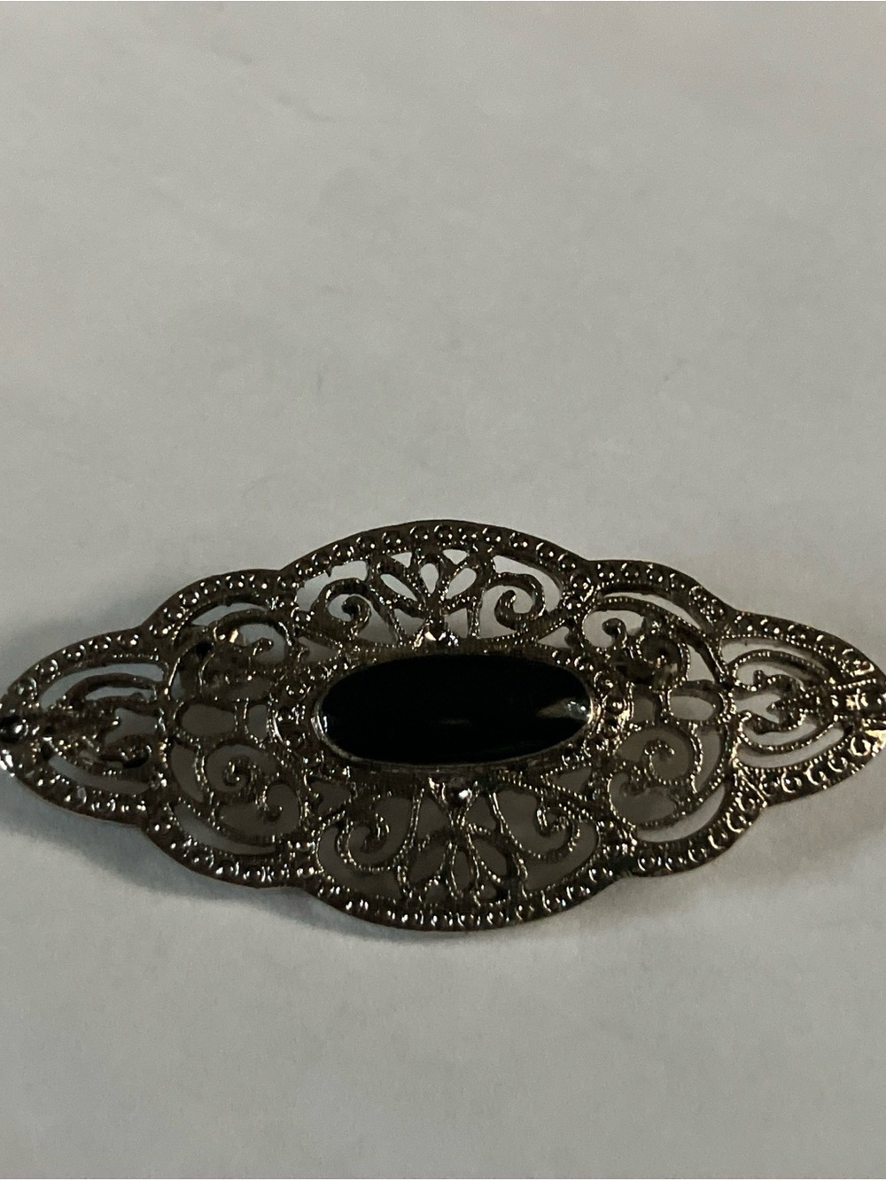 Ornate Filigree Brooch with Black Stone Accent